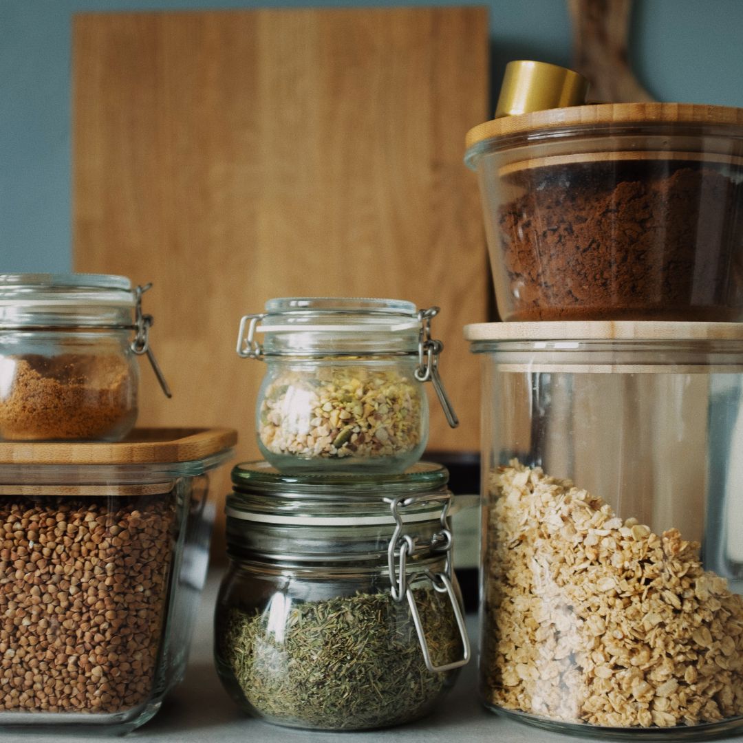 Jars containing pantry items such as lentils, oats and sugar